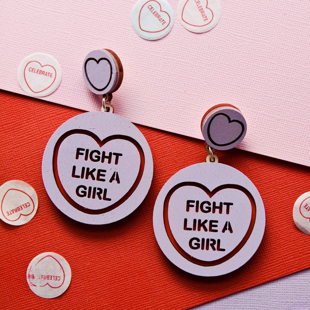 Candy & Kitsch candy heart earrings sits in a kitsch interior design in the variation ’fight like a girl'