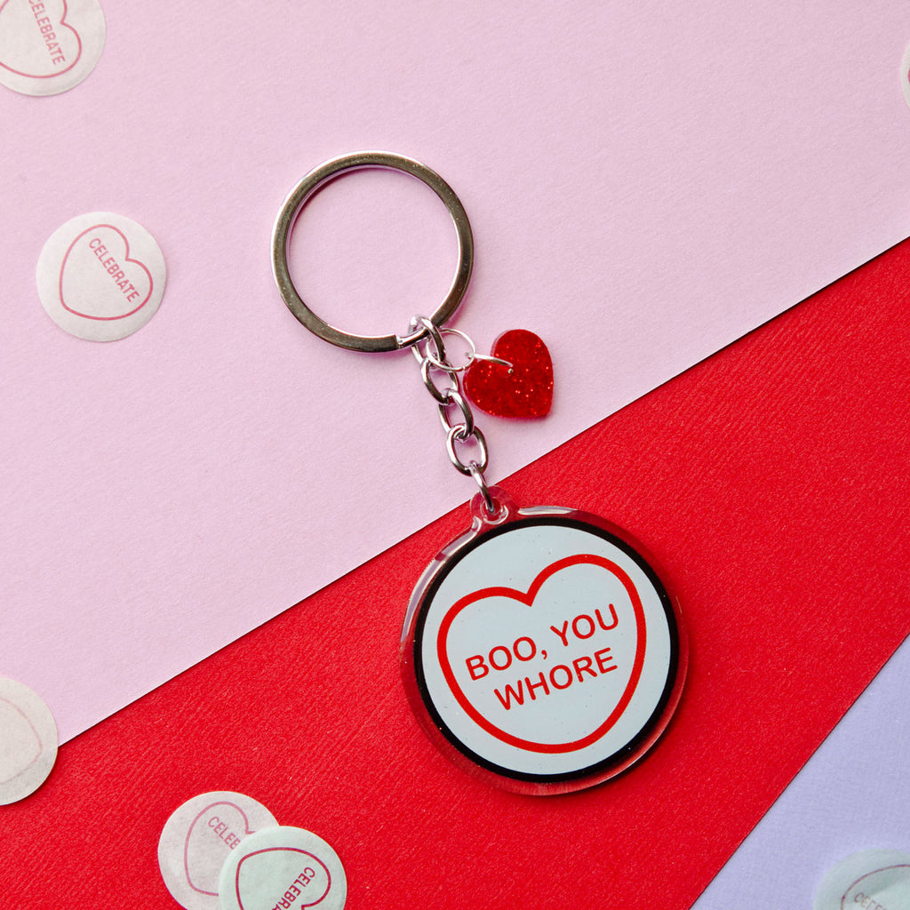 Candy & Kitsch candy heart keyring keychain sits in a kitsch interior design in the variation ’Boo you Whore' inspired by Mean GirlsCandy & Kitsch candy heart keyring keychain sits in a kitsch interior design in the variation ’Boo you Whore' inspired by Mean Girls