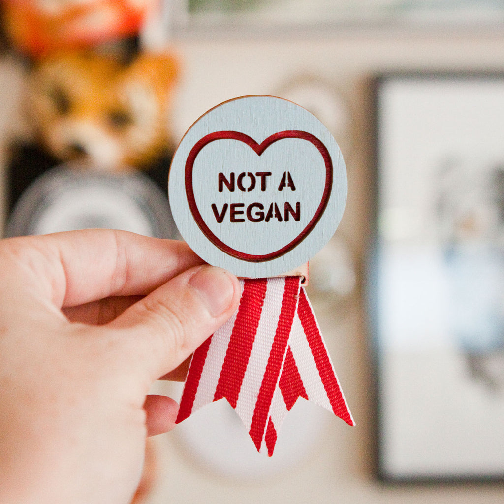 Candy & Kitsch 'not a vegan' adult merit badge brooch is handmade in Australia and shown here in an alternative kitsch aesthetic background
