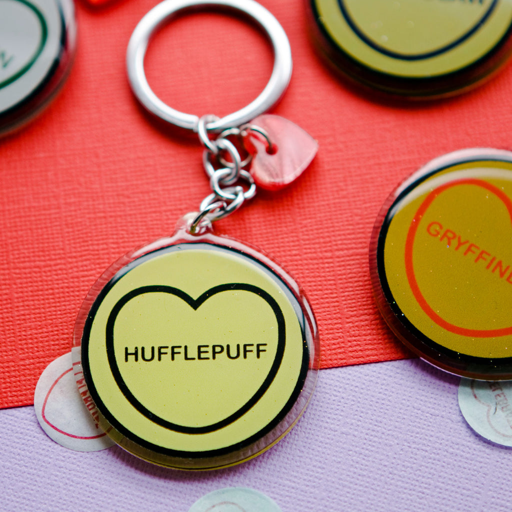 candy and kitsch harry potter candy hearts hogwarts house Hufflepuff keyring sits in a colourful background with candy heart confetti